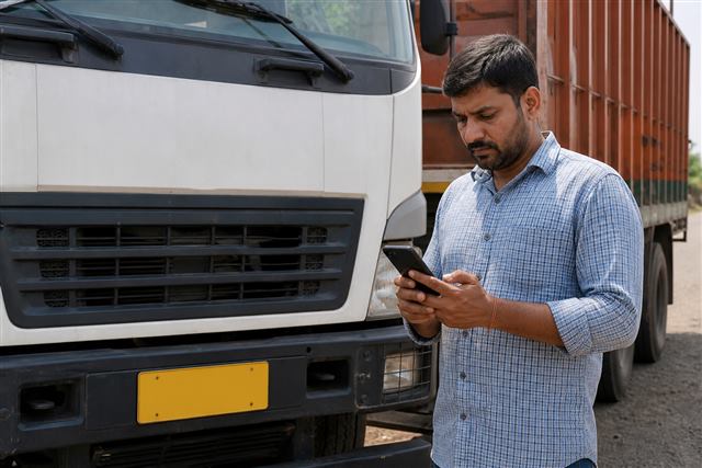 Person checking a truck number plate for RC search
