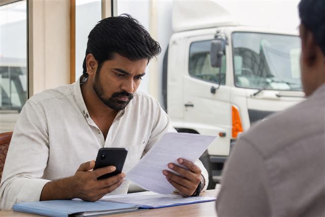 Buyer comparing RC data with vehicle documents to reduce fraud